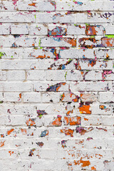 vertical texture of a brick wall with peeling paint. background in the form of an old painted brick wall. painted brick wall. vertical photo