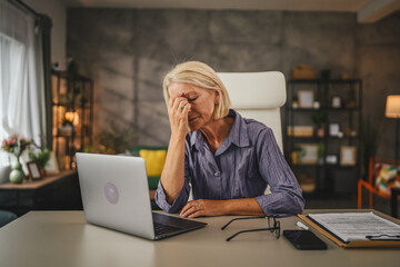 Mature senior woman work from home and have eyestrain pain