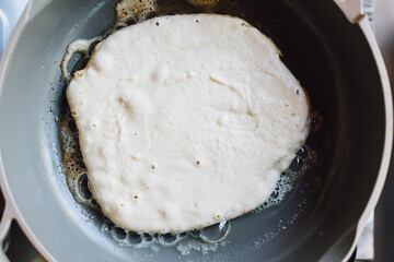 cooking pancakes in a frying pan