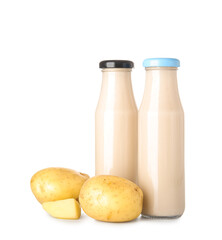 Bottles of tasty potato milk on white background