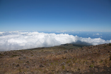 High Altitude Landscape with Rolling Clouds and Clear Blue Sky