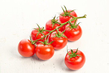 Cherry tomatoes on a white wooden textured background. Close-up of cherry tomatoes.