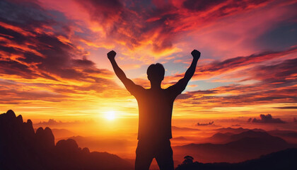 Fototapeta premium The silhouette of a man with his arms raised in victory, facing a stunning sunrise