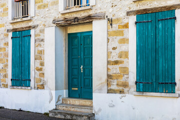 Stone House with Teal Wooden Shutters