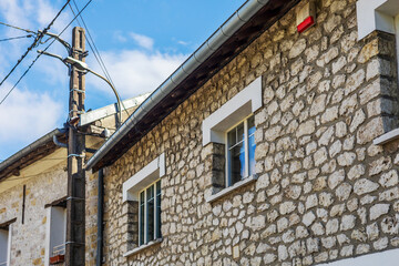Stone House with Utility Pole and Wires