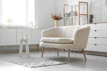 Stylish interior of living room with white sofa and window