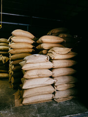 in a spacious warehouse in Panama, numerous jute bags brimming with freshly harvested coffee beans...