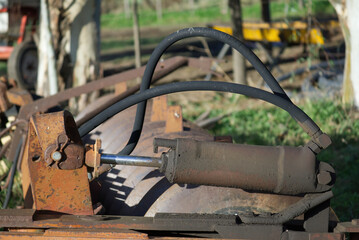 Leaking hydraulic fluid on rusty agricultural machinery piston