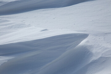 Fresh White Wintery Wind Blown Snow Drifts Background Image With Highlights and Shadows