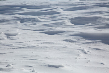 Fresh White Wintery Wind Blown Snow Drifts Background Image With Highlights and Shadows