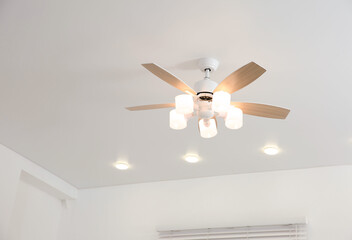 Ceiling fan with lamps indoors, low angle view