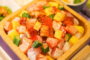 colorful salmon roe seafood rice bowl with diced tamagoyaki egg, okra cubes, chopped eel. unagi don bento lunch set