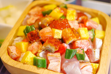 colorful salmon poke sashimi rice bowl texture diced tamagoyaki okra cubes chopped eel unagi don bento top view