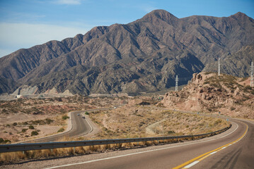 Curvy roads in a mountainous Andean area in Mendoza, Argentina. Concept: vacations traveling by car, heading towards the mountains.