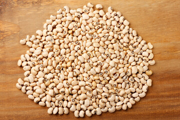 Raw dried black eyed peas bean pile isolated on wooden table