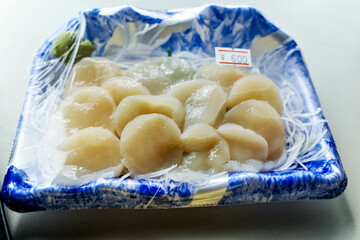 A pack plate of fresh scallops being sold in a fisherman cooperative shop in Japan