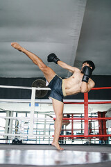 Full Length Of Asian Muaythai Man Showing Kicking Attack With Foot Technique. MMA, UFC And Kickboxing Concept