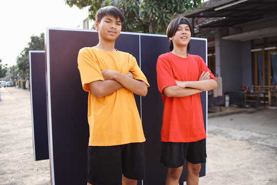Potrait Of Confidence Ping Pong Asian Team Man Keeping Crossed Arms Against Ping Pong Table Background