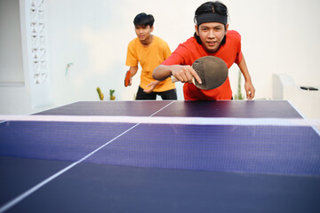 Potrait Of Young Asian Guy Ready To Blocked Ping Pong Ball With Backhand Style In Ping Pong Team...