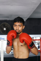 Potrait Of Serious Young Asian Fighter Guy Showing Stance And Ready To Fight For Boxing Match