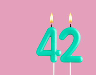 Birthday card with green number 42 candle - Pastel pink background