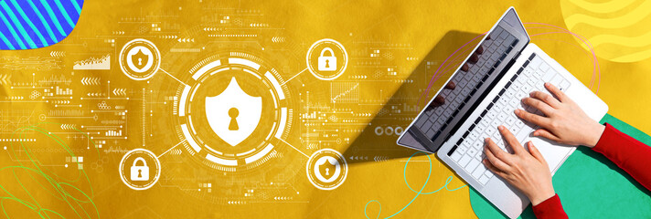 Cyber security theme with person using a laptop computer