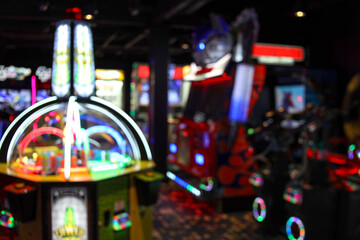 Blurred image of vintage arcade games in a dark room