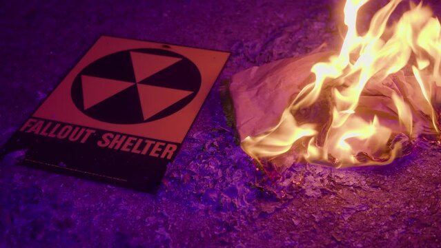 A fallout shelter sign with fire