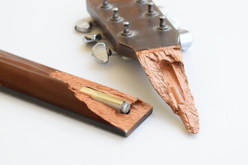 part of broken wood acoustic guitar isolated on white background