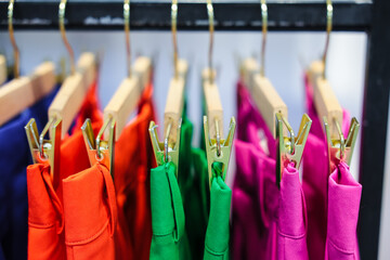 Colorful pants on hangers in a clothing store, Summer concept