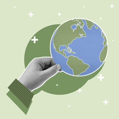 A human hand holding a globe