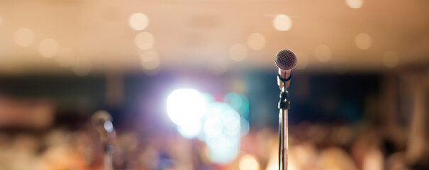 Microphone in concert hall or conference room soft and blur style for background. Microphone over...