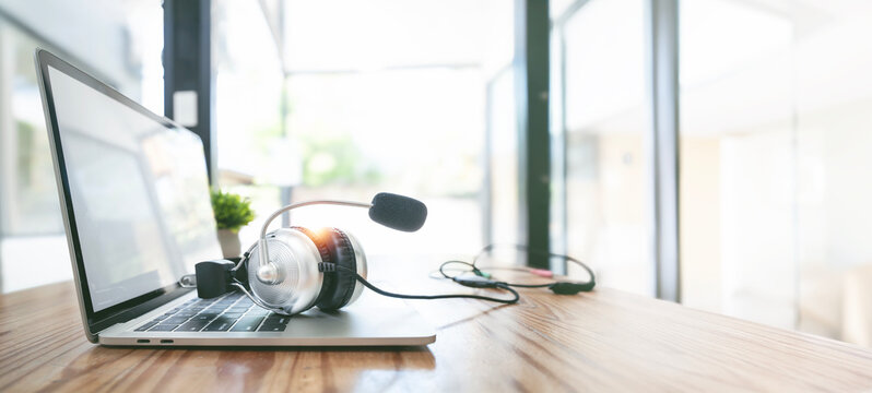 Headset on laptop. Business Operator in Office.