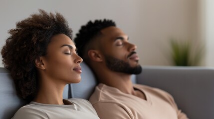 Obraz premium a couple sitting on a sofa in a counseling room, side by side with their eyes closed, in a counseling center
