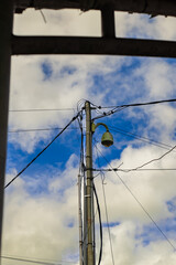 Electric cable pole with street lighting at the end