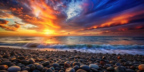 Sunset over colorful pebbled beach with dramatic sky and waves, sunset, pebbled beach, colorful, dramatic sky, waves, nature, tranquil, serene, water, ocean, scenic, beautiful, natural