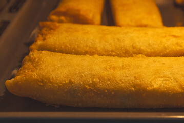 Lumpia baked in the oven. Appetizing close-up of baked lumpia inside