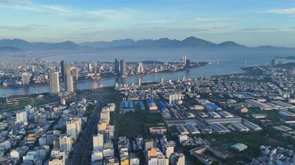 Aerial view drone video Da Nang coastal city at morning, cityscape with  dragon or Rong bridge,  crowded urban near coastline, sea destination for Vietnam vacation travel