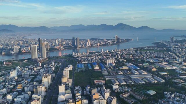 Aerial view drone video Da Nang coastal city at morning, cityscape with  dragon or Rong bridge,  crowded urban near coastline, sea destination for Vietnam vacation travel