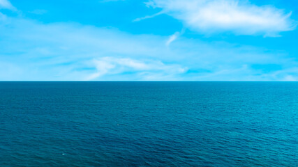 Ocean sea background and the clear sky For summer vacation ideas Nature of summer sea water with sunlight The sea sparkles against the blue sky	
