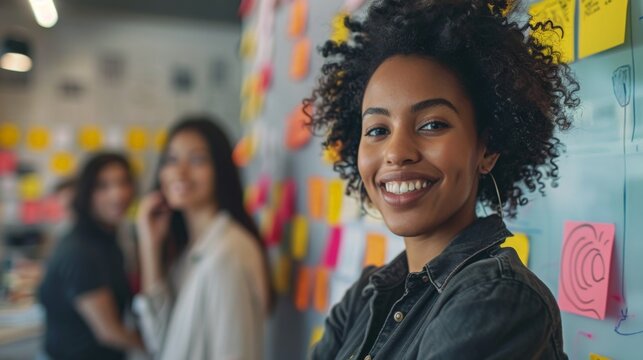 Female graphic designer looking at sticky notes
