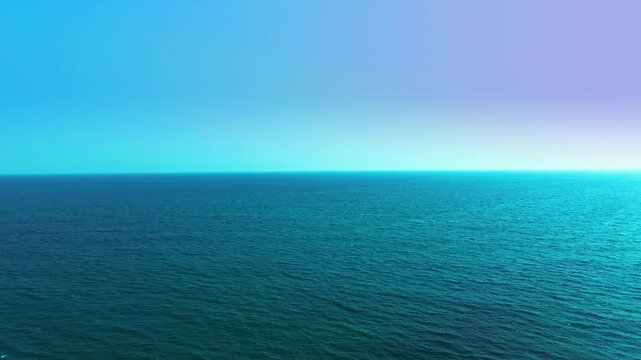 Ocean background and sea water and clear sky. For summer vacation ideas The nature of the beach and summer sea with the sun shining on the sea sparkling against the blue sky.