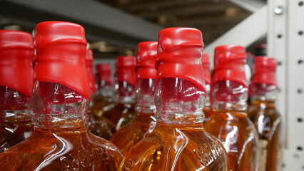 Close-up of many whiskey bottles with red sealing wax corks
