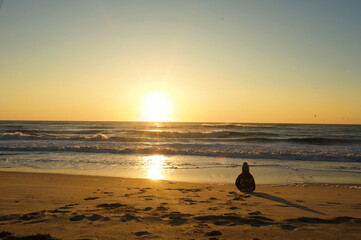 Young child watching sunrise at Cape Hatteras National Seashore