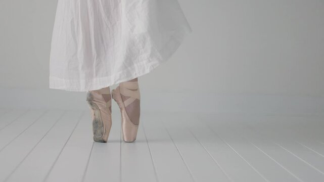 close up of ballerinas feet on tip toes in point shoes