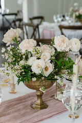 elegant white floral centerpiece on table at wedding reception