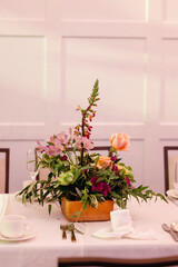 Elegant table centerpiece with mixed flowers in a wooden box.
