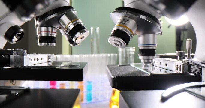 Microscopes with interchangeable lenses stand in laboratory