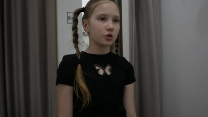 Dissatisfied irritated Caucasian girl vlogger model influencer frown looking choosing clothes. Stylish popular female blogger girl standing in fitting room in clothing store and putting uncomfortable 