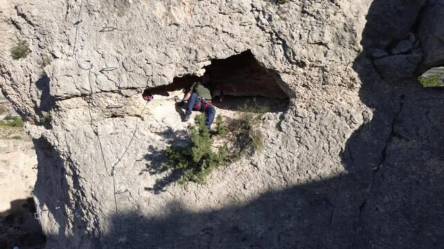 Man rock climbing aerial view of sportsman rapelling mountain in La Panocha, el Valle Murcia, Spain woman rapel down a mountain climbing a big rock